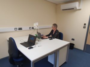 Bruton meeting room. There is a square desk with room to work on a laptop on both sides.