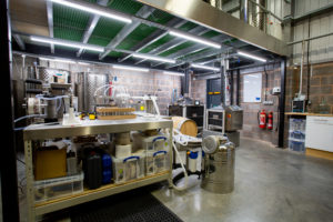 The inside of Barle Exmoor Distillery workspace. It's an industrial space with lots of equipment.