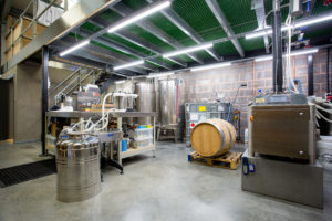 The inside of Barle Exmoor Distillery workspace. It's an industrial space with lots of equipment.