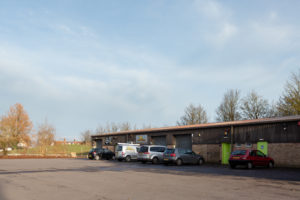 An outside view of the units, there is a large parking area.