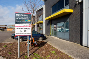 Minehead Enterprise Centre entrance and The Hub signage. There is a paved walkway outside.