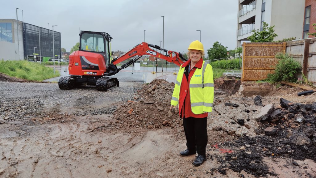 Image of Cllr Rose Wyke beside a digger at the start of works on the Firepool Boulevard.