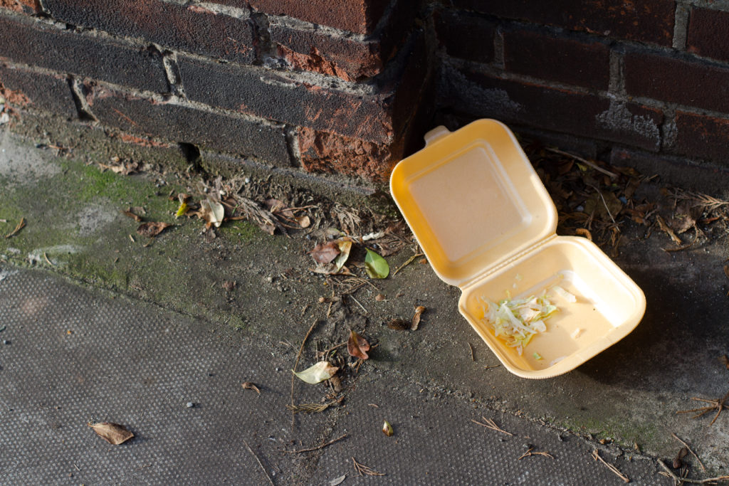 Take away fast food box on pavement.