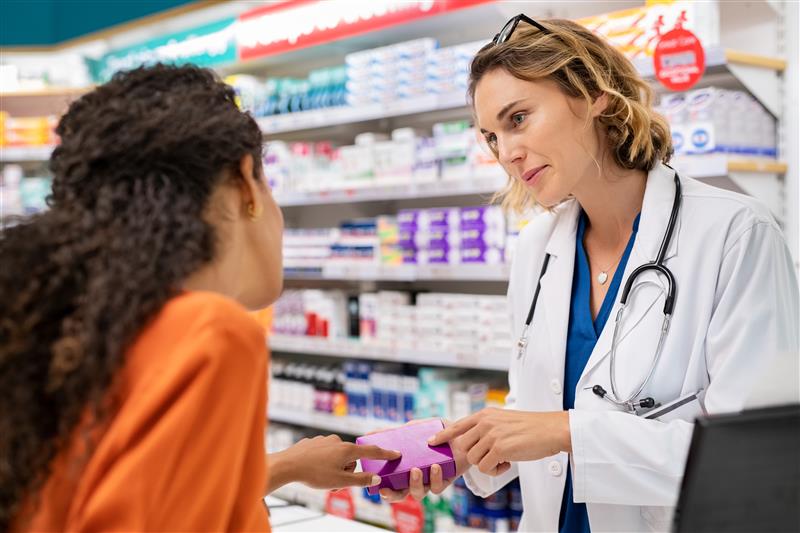 A pharmacist advising a customer.