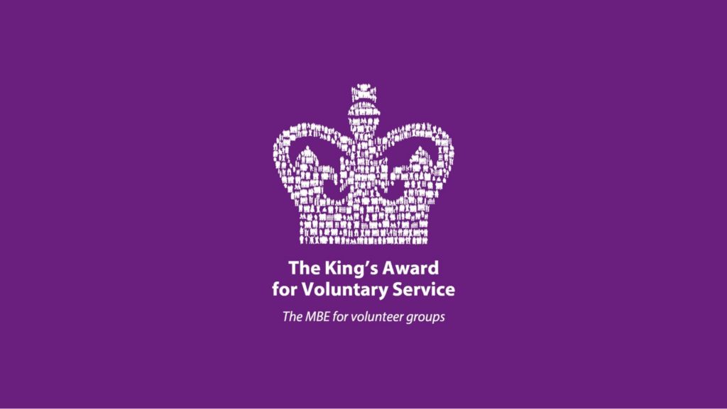 Photo shows the logi for the Kings Awards for Voluntary Service - a white crown on a purple background