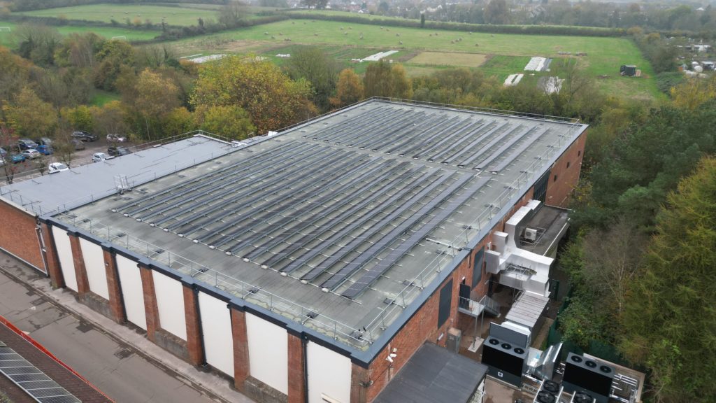 An aerial view of Wellington Sports Centre showing an array of solar panels and other decarbonisation features including air source heat pumps.