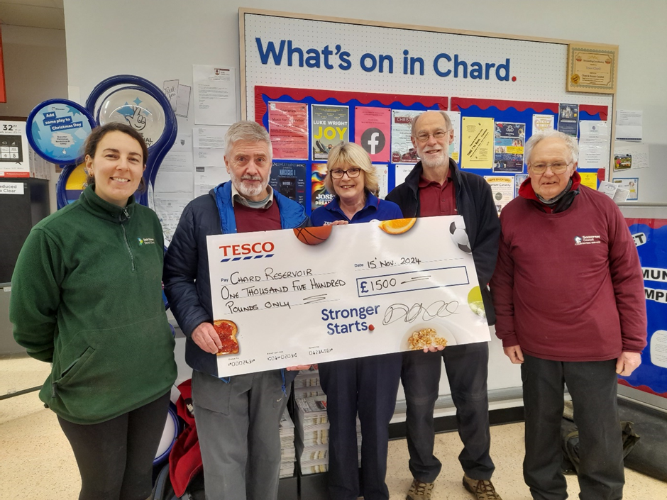 At Tesco Chard. Some of the team from Chard Reservoir receiving their check from tesco representative