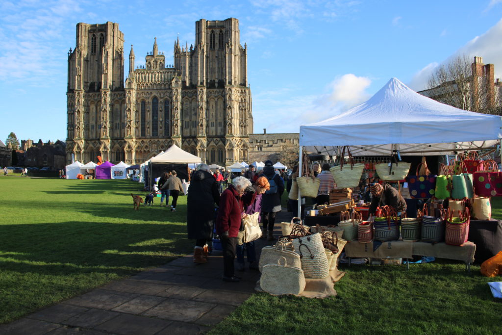 Wells christmas market with stalls in font the Cathedral.