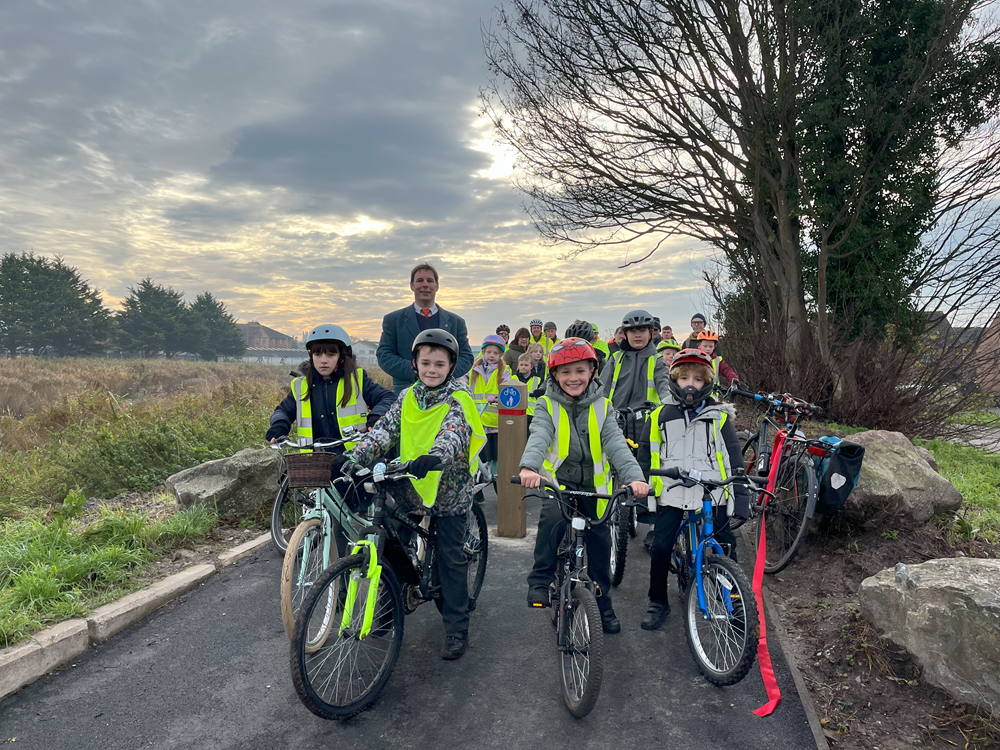 A group of Children from Northgate Primary School on their bikes with Councillor Richard Wilkins posing for the camera on the new cycle route between Linham road and the docks in Bridgwater.