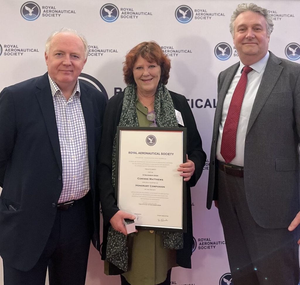 Corinne Matthews holding her certificate with RAeS members.