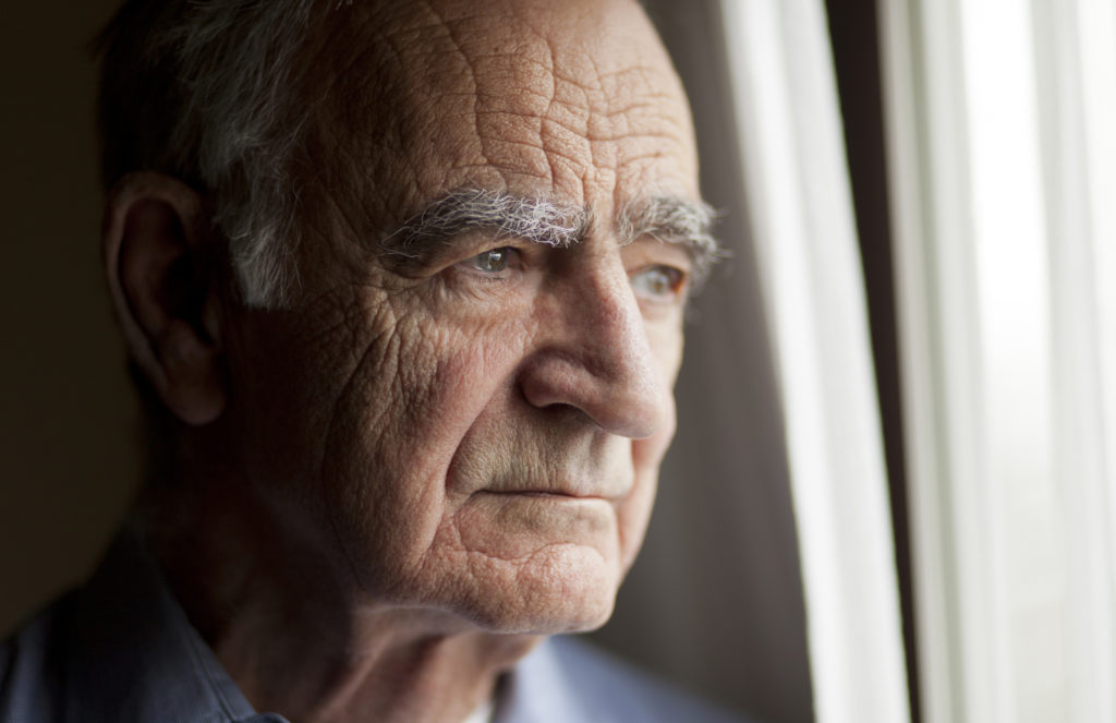 Portrait of elderly man lost in thought.