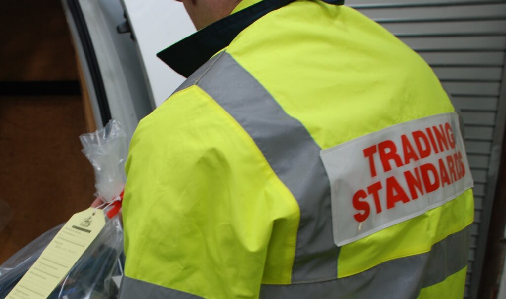 A Trading Standards Officer confiscating goods from a loot van.