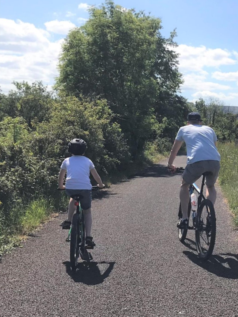 A father and son cycling along an active travel path in Yeovil.